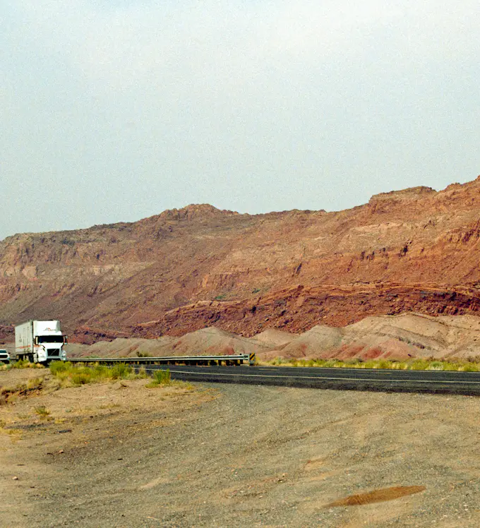 Truck on a highway by rocky hills